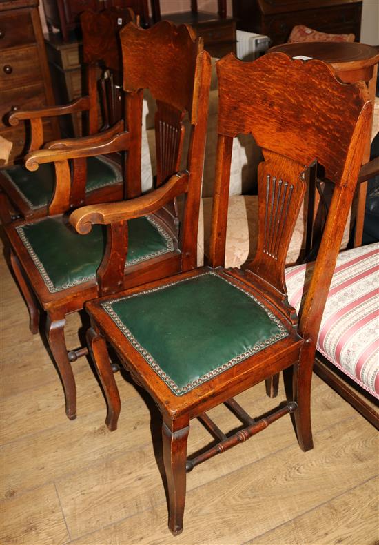 A pair of Edwardian oak elbow chairs and a matching single chair